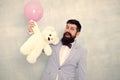 Man wear tuxedo bow tie. Romantic man with teddy bear and air balloon waiting girlfriend. Romantic gift. Macho ready