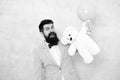 Man wear tuxedo bow tie. Romantic man with teddy bear and air balloon waiting girlfriend. Romantic gift. Macho ready