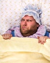 Man weared as baby angry in bed Royalty Free Stock Photo