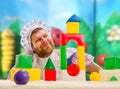 Man weared as baby play indoor Royalty Free Stock Photo