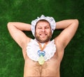 Man weared as baby resting Royalty Free Stock Photo