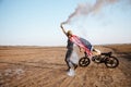 Man wearing american cape and golden helmet holding smoke bomb Royalty Free Stock Photo