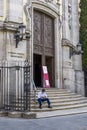 A man wearing an anti covid-19 mask sitting on the steps of the BasÃÂ­lica pontificia de San Miguel, Madrid