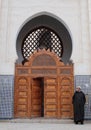 Man wearing arab djellaba next to Mosque entrance