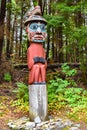 Man Wearing Bear Hat Totem Pole at Totem Bight State Historical Park, Alaska.