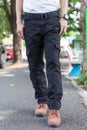 Man wearing black cargo pants and standing in the nature park