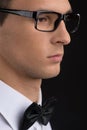 Man wearing black glasses on dark background. Royalty Free Stock Photo