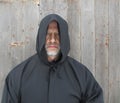 Man Wearing a Black Hooded Cape