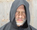 Man Wearing a Black Hooded Cape Staring