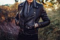 Man wearing black leather jacket and watch posing outdoors Royalty Free Stock Photo