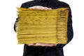Man in black uniform holds a stack of padded bubble envelopes isolated on white Royalty Free Stock Photo