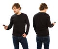 Man wearing blank black shirt holding phone Royalty Free Stock Photo