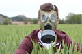 Man wearing breathing mask in wheat field