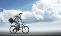 Man wearing business suit riding bicycle outdoor. Royalty Free Stock Photo