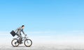 Man wearing business suit riding bicycle outdoor. Royalty Free Stock Photo