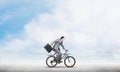 Man wearing business suit riding bicycle outdoor. Royalty Free Stock Photo