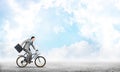 Man wearing business suit riding bicycle outdoor. Royalty Free Stock Photo