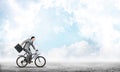 Man wearing business suit riding bicycle outdoor. Royalty Free Stock Photo