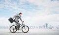 Man wearing business suit riding bicycle outdoor. Royalty Free Stock Photo