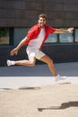 Man wearing casual clothes jumping in urban background. Royalty Free Stock Photo