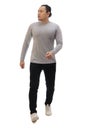 Man wearing casual grey shirt black denim and white shoes, walking forward, moving with confidence. Full body portrait isolated Royalty Free Stock Photo