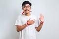 Man wearing casual shirt swearing with hand on chest and open palm, making a loyalty promise oath Royalty Free Stock Photo