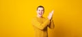 Man wearing casual sweater over yellow background clapping and applauding happy and joyful, smiling proud hands together. Royalty Free Stock Photo