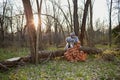 Two people wearing animal costumes sitting by tree