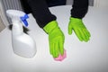 A man wearing cleaning gloves wipes the dining table. Royalty Free Stock Photo