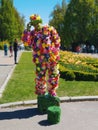 Man wearing a costume with colorful flowers greeting visitors in the Kyiv National Botanical Garden