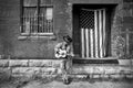 Man wearing cowboy hat and blue jeans playing acoustic guitar and american flag Royalty Free Stock Photo