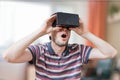 Man is wearing 3D virtual reality headset and is fascinated