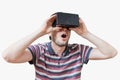 Man is wearing 3D virtual reality headset and is fascinated. Royalty Free Stock Photo