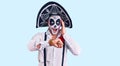 Man wearing day of the dead costume over background looking at the watch time worried, afraid of getting late Royalty Free Stock Photo