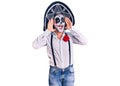 Man wearing day of the dead costume over background smiling cheerful playing peek a boo with hands showing face