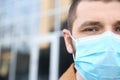 Man wearing disposable mask, closeup. Dangerous virus