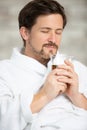 man wearing dressing-gown enjoys aroma from tea Royalty Free Stock Photo