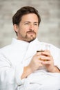 man wearing dressing-gown relaxes holding cup tea Royalty Free Stock Photo