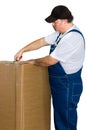 Man wearing dungarees opening large cardboard box