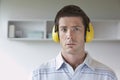 Man Wearing Ear Protectors In Office Royalty Free Stock Photo