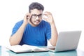 Man wearing eyeglass using laptop