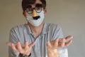 Man wearing face mask and Groucho glasses