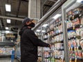 Man wearing a face mask and shopping in the deli meat and cheese aisle during the COVID-19 pandemic