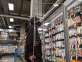 Man wearing a face mask and shopping in the deli meat and cheese aisle during the COVID-19 pandemic