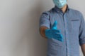 Man wearing face medical mask and blue rubber latex gloves