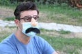 Man wearing fake nose, eyeglasses, mustache and PPE