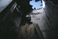 A man wearing a gas mask inside a ruined building in the dark