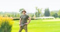 Man wearing green shirt standing in grassy field Royalty Free Stock Photo