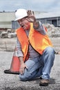 Man wearing hard hat and safety vest at construction site holding hand up to stop and yelling Royalty Free Stock Photo