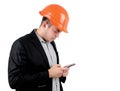 Man wearing a hardhat checking his mobile Royalty Free Stock Photo